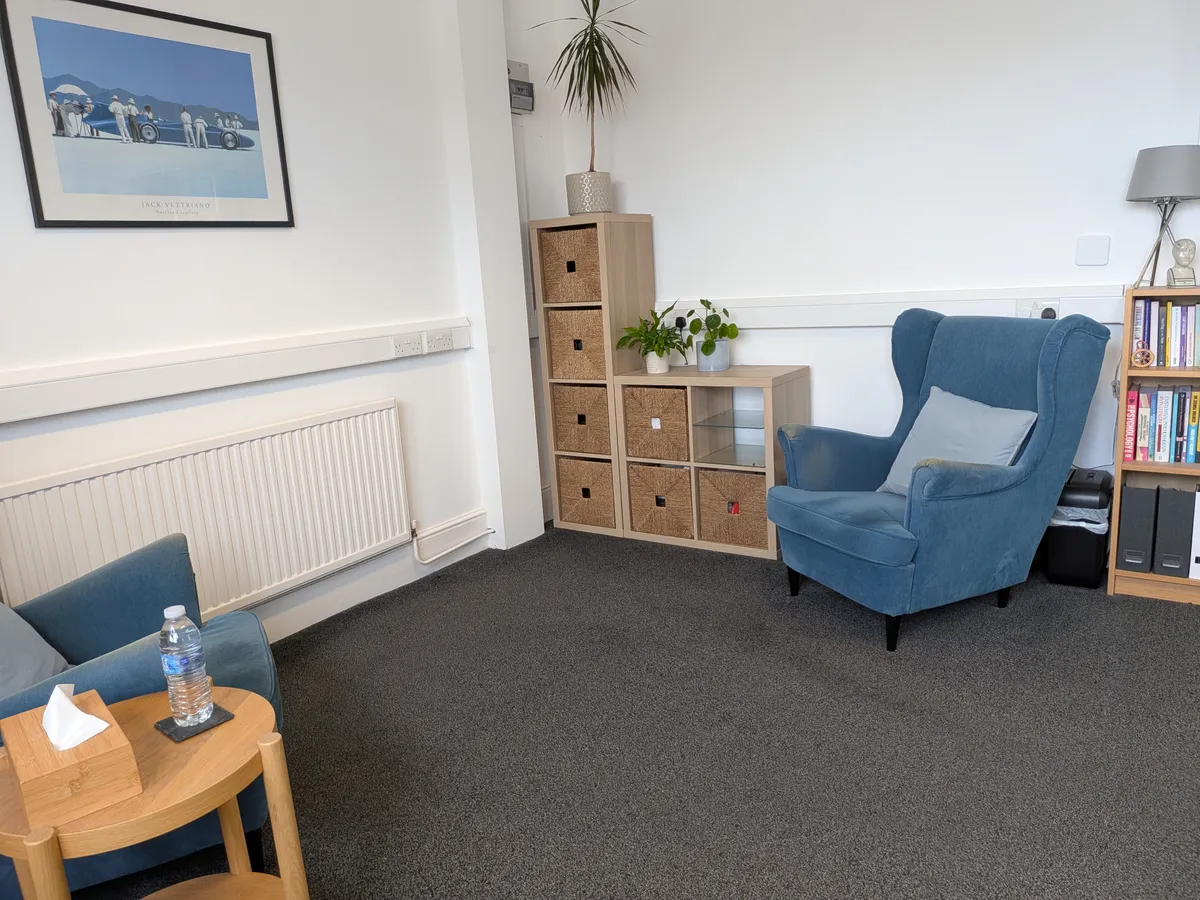 Worcester Park Counselling therapy room with two armchairs and a side table